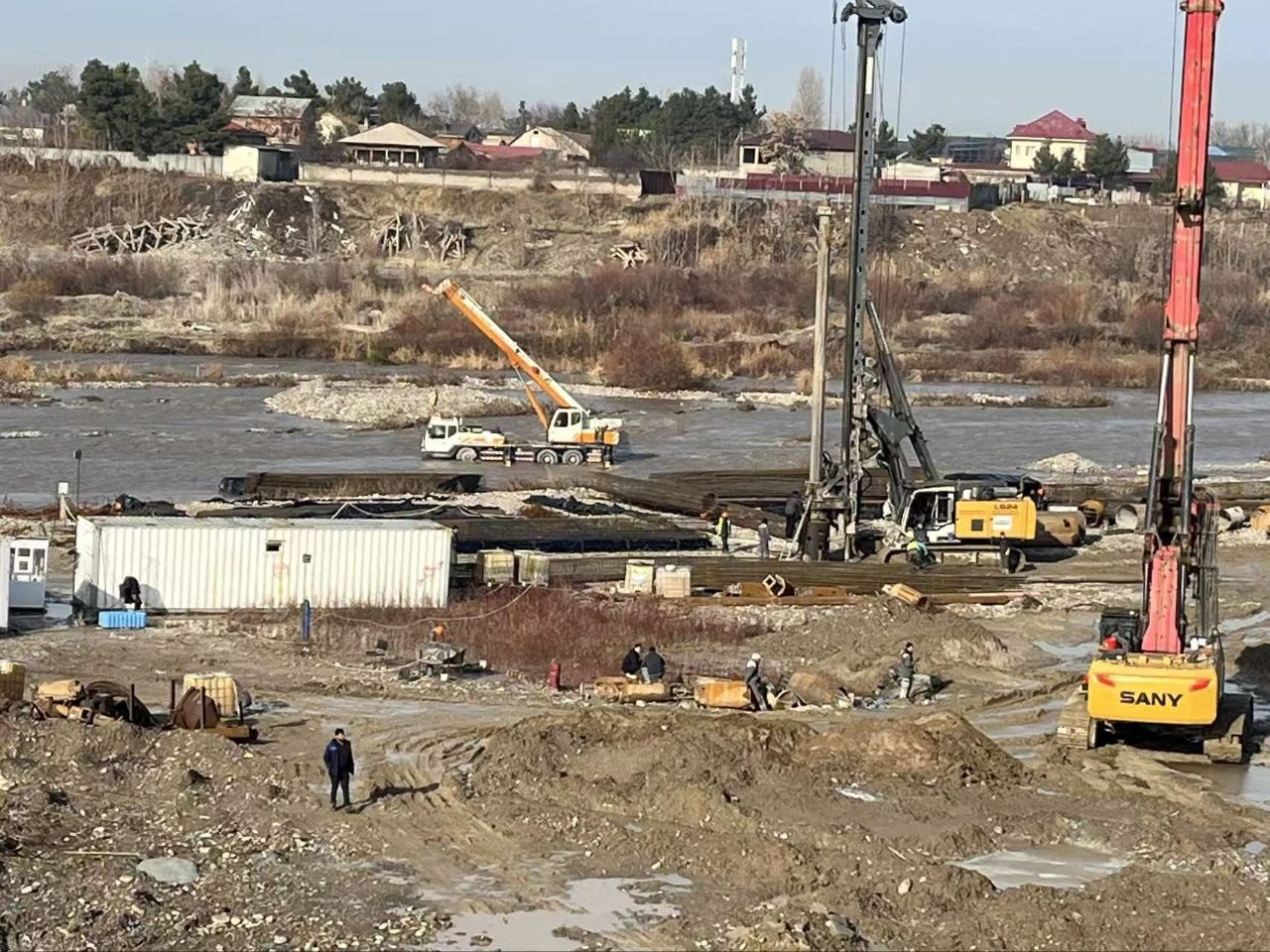 Multiple piling rigs working along riverside foundation site